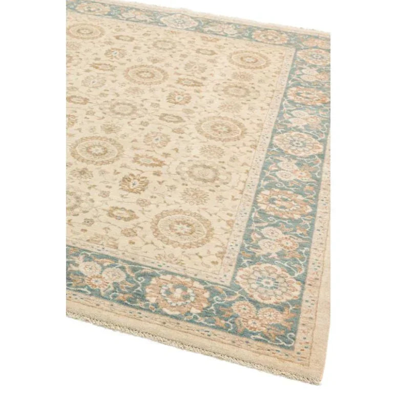 Traditional cream area rug with blue floral border and intricate medallion pattern