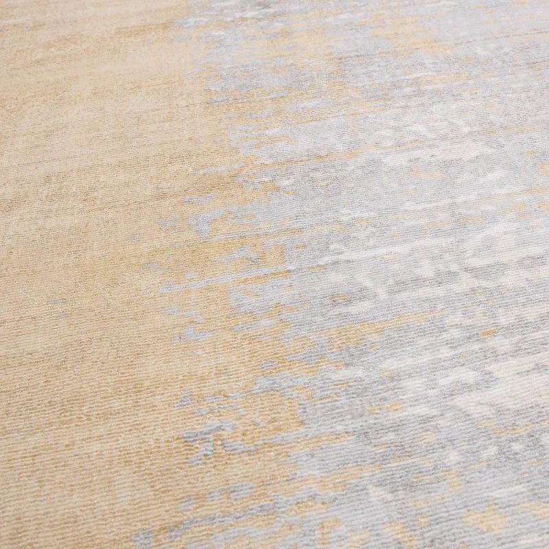 Beige and grey area rug with subtle abstract pattern and soft textured surface
