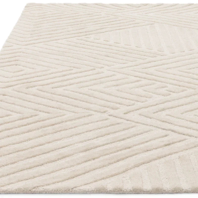 cream geometric rug with textured pattern shown at an angle
