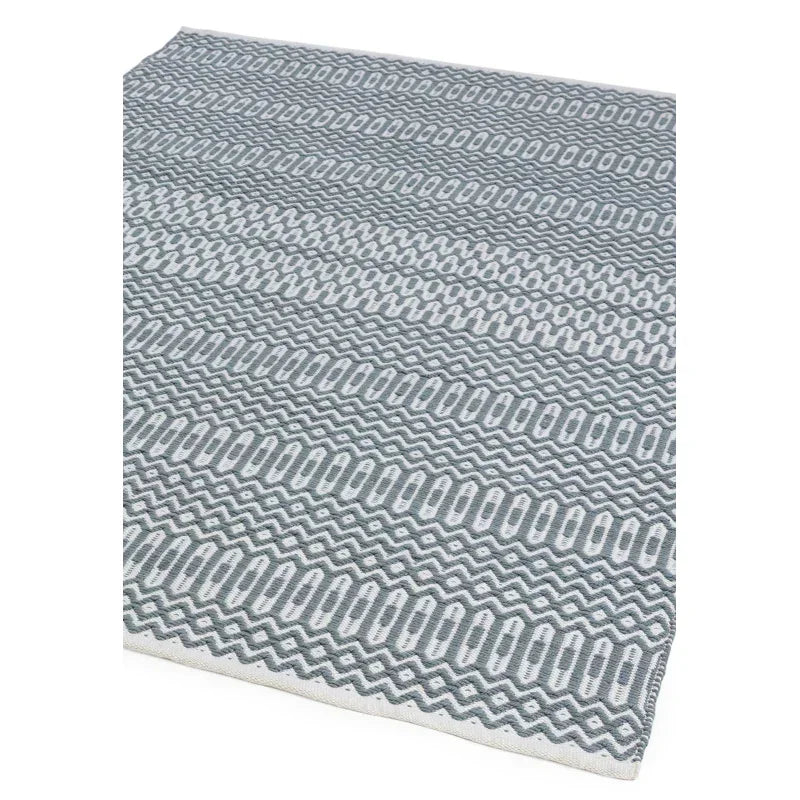Grey patterned area rug with geometric design and textured surface