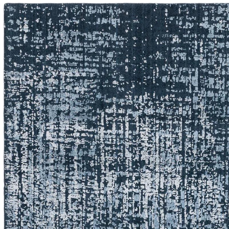 Blue abstract pattern rug with textured design and square corner detail