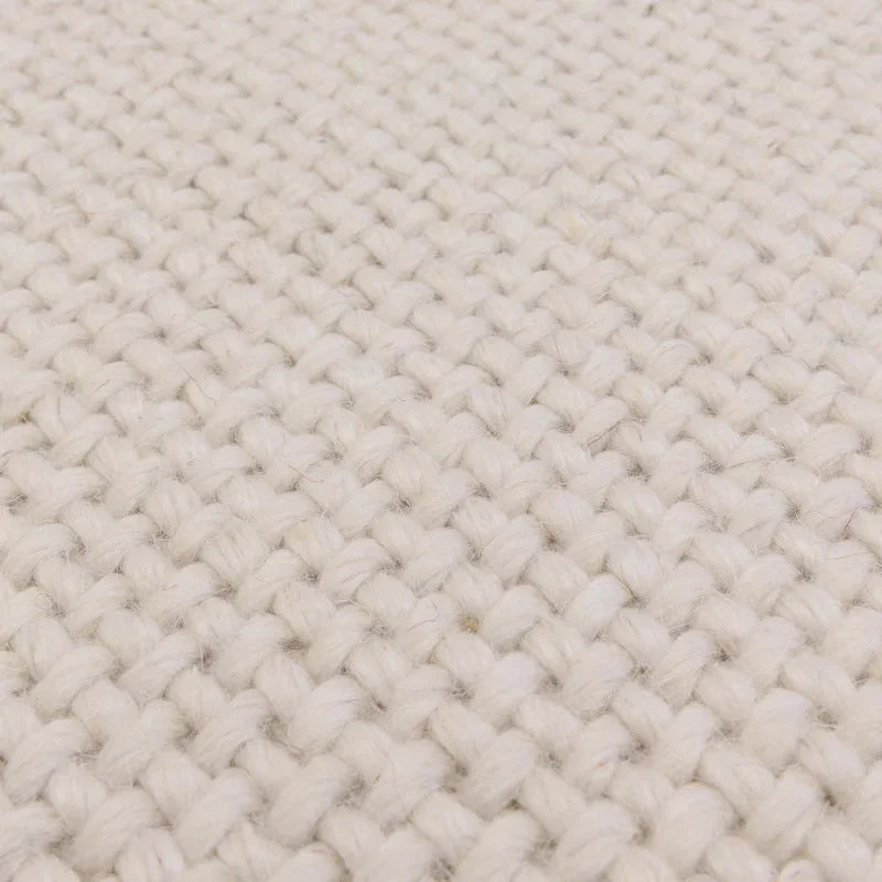 Close-up of cream woven wool rug texture