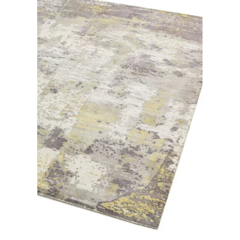 Modern area rug with abstract grey and yellow pattern, angled corner view
