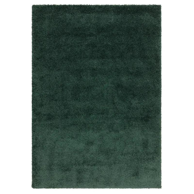 Dark green shaggy rug with thick pile and rectangular shape