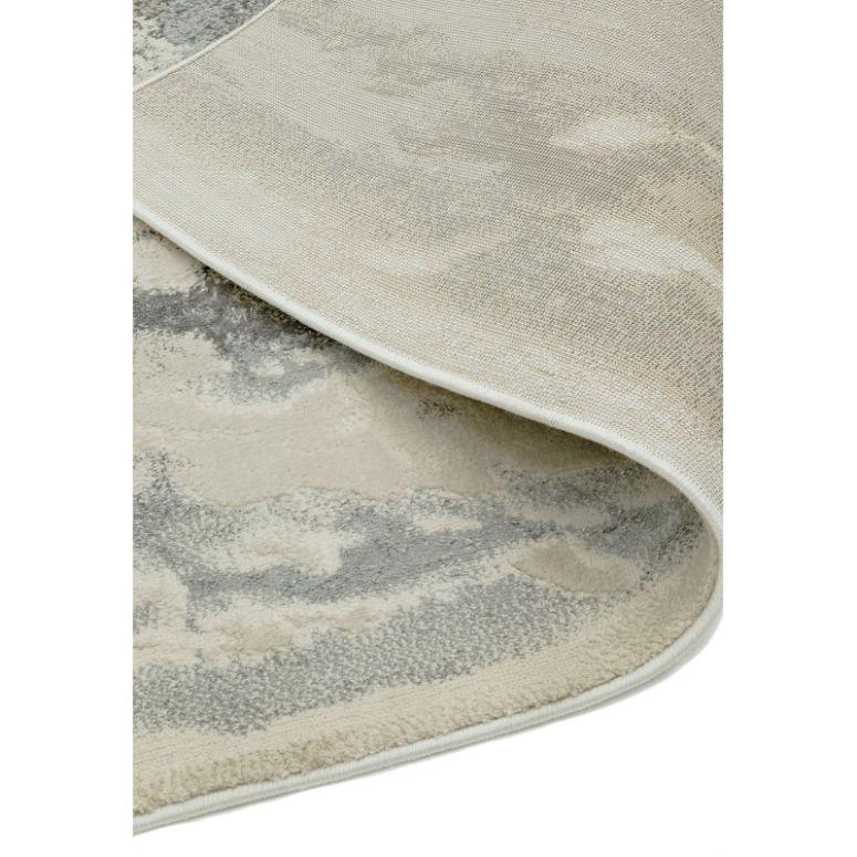 Beige and grey area rug with abstract pattern, close-up of corner detail and texture