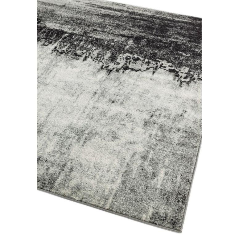Grey abstract area rug with textured pattern and soft pile, shown at an angle