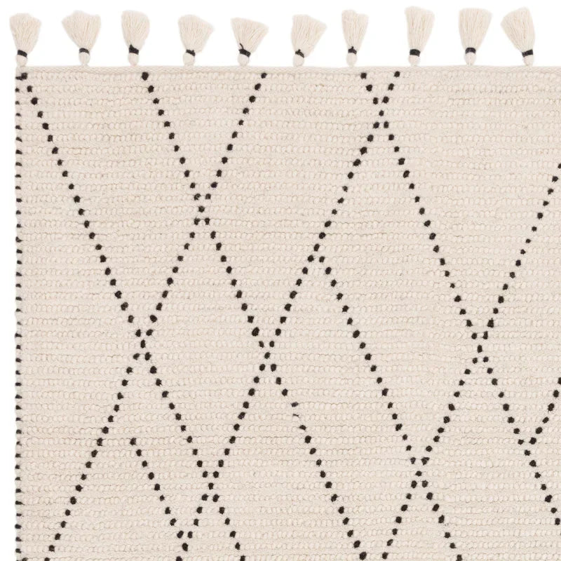 cream patterned rug with black diamond lines and tassel edge detail