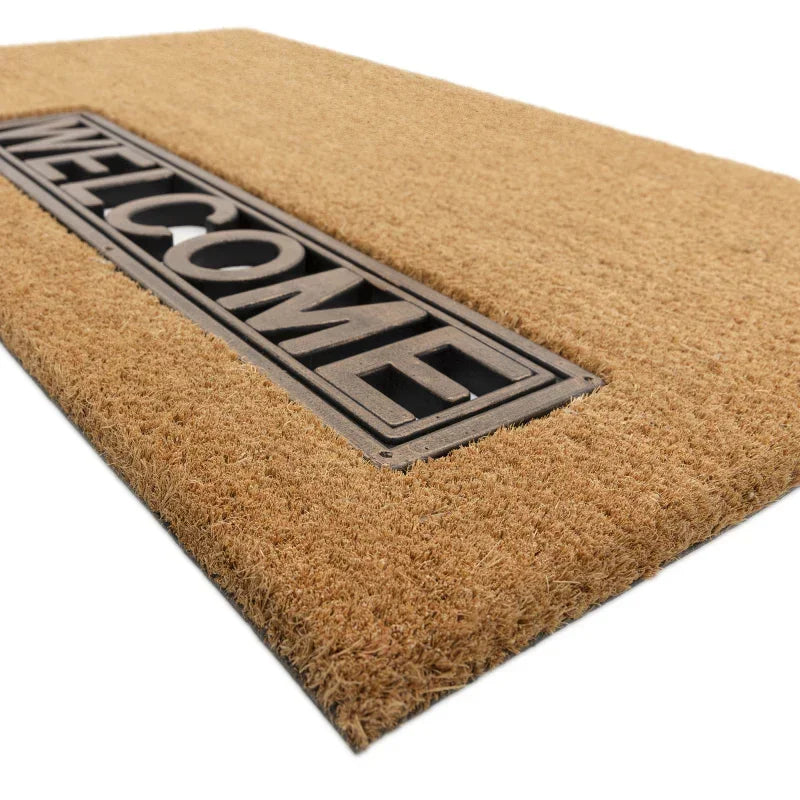 Coir welcome doormat with black rubber inlay lettering, shown at an angle