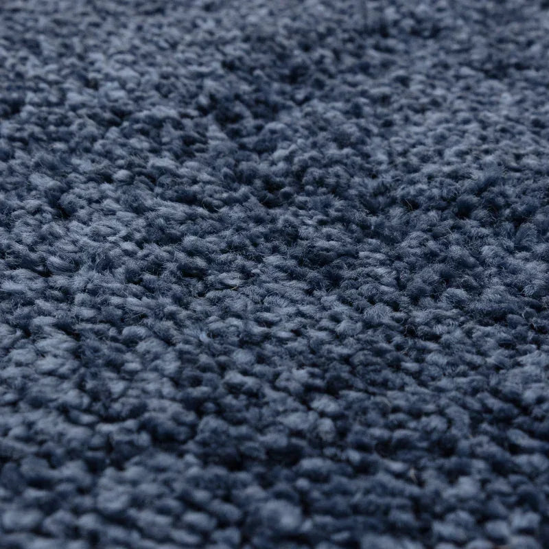 Close-up of dark blue textured rug pile fabric