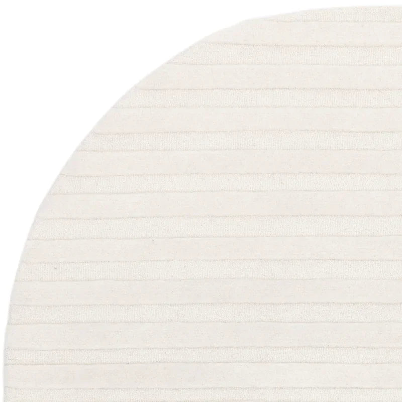 closeup of cream round rug with subtle striped texture pattern
