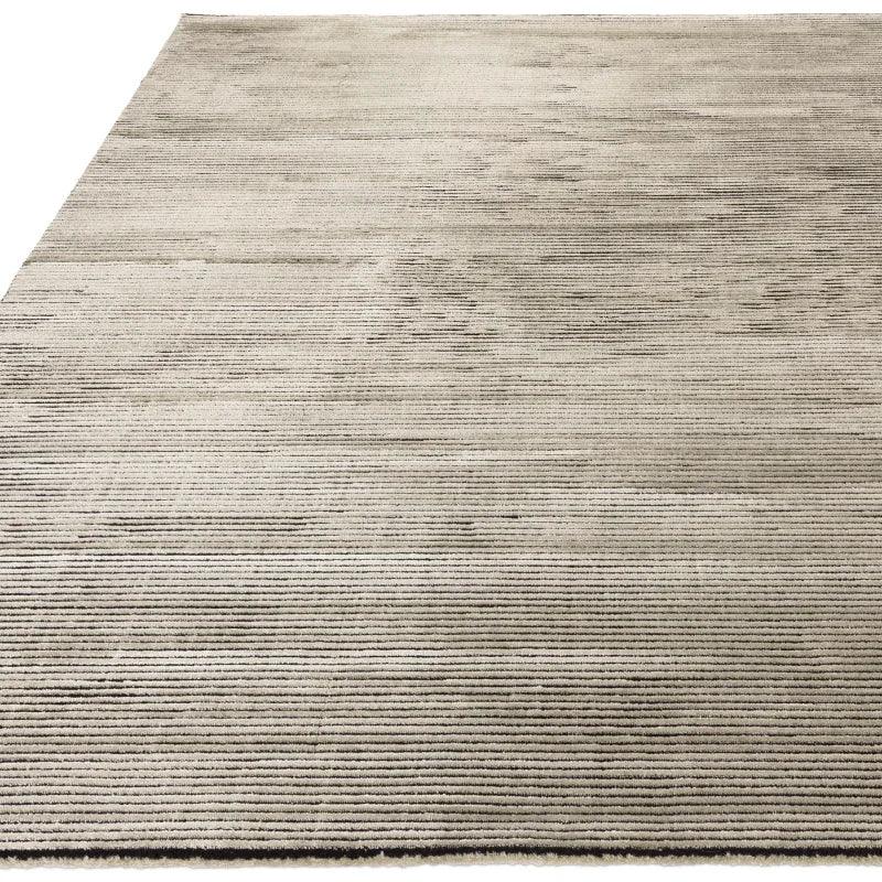 Large beige area rug with subtle linear texture and low pile design