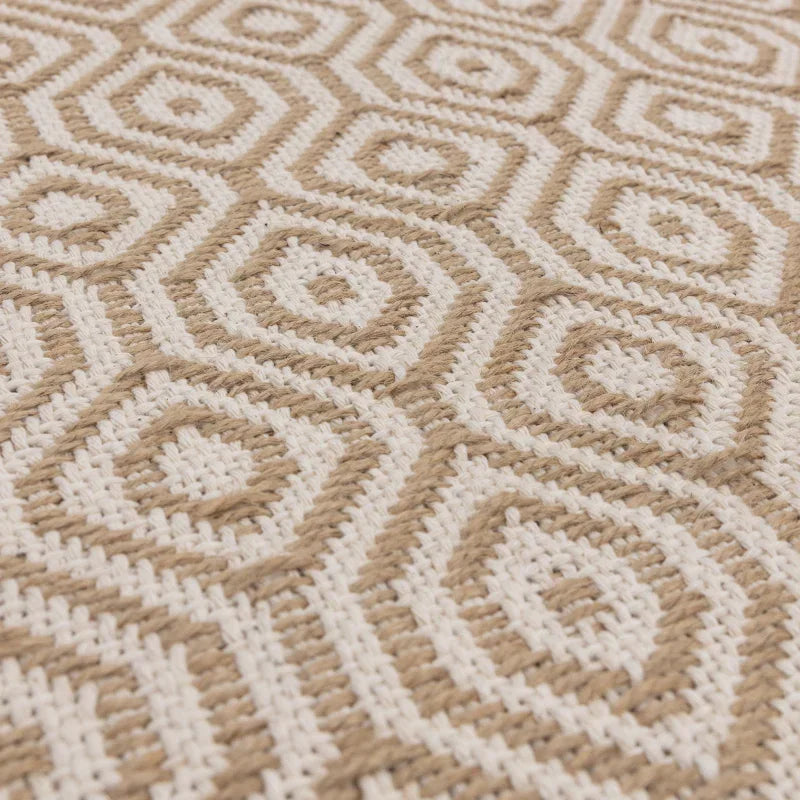 Close-up of beige and white geometric woven rug texture
