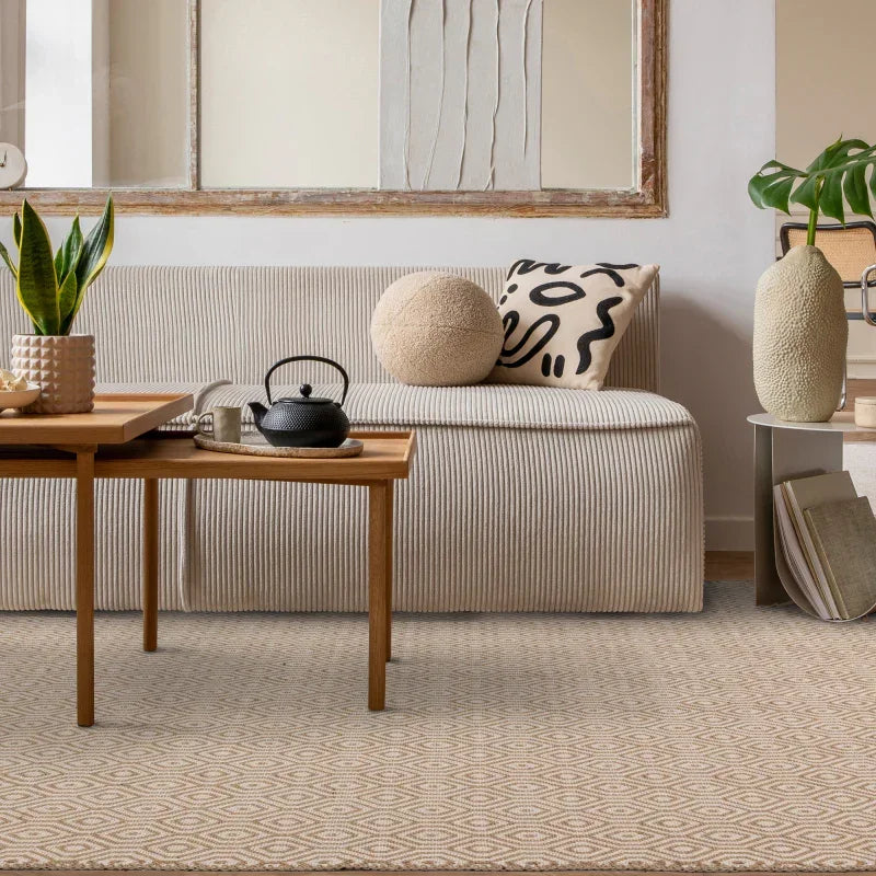 Beige sofa with textured cushions, wooden coffee table and indoor plant in living room