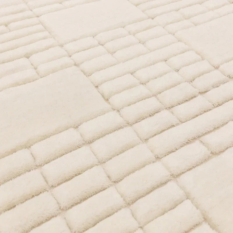 Cream geometric rug with raised textured pattern, close-up of soft pile detail