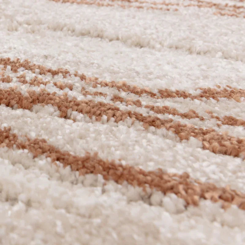 Close detail of cream and beige patterned shaggy rug texture