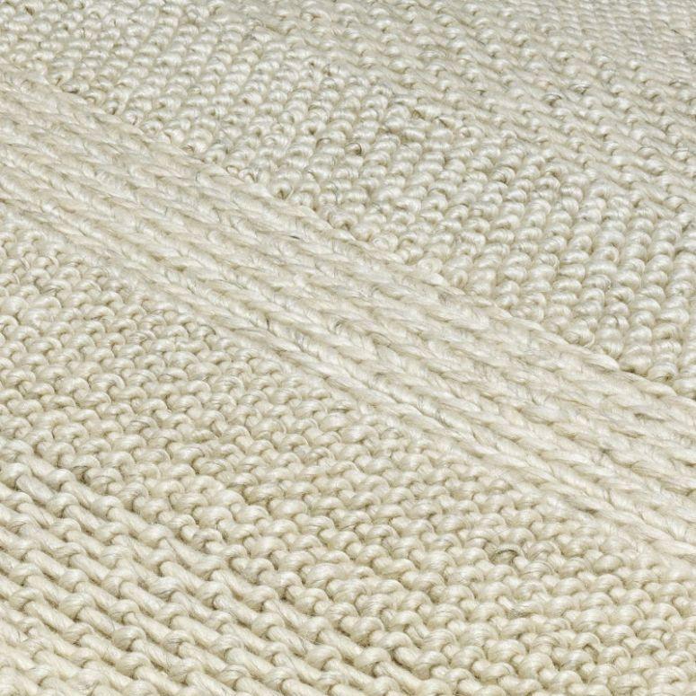 Close-up of cream wool rug texture with woven pattern