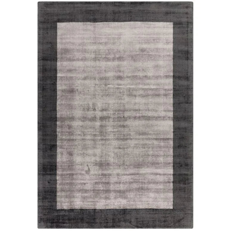 Rectangular grey area rug with light central panel and dark border, modern living room decor