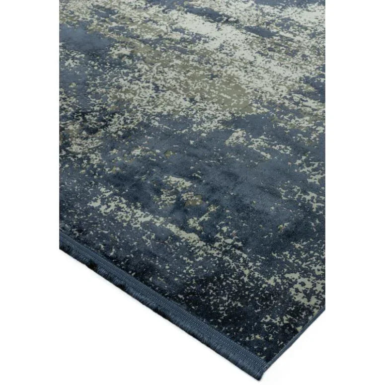 Modern blue and grey area rug with abstract textured design, corner angle view