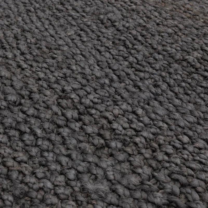 Close up of dark grey woven wool rug texture