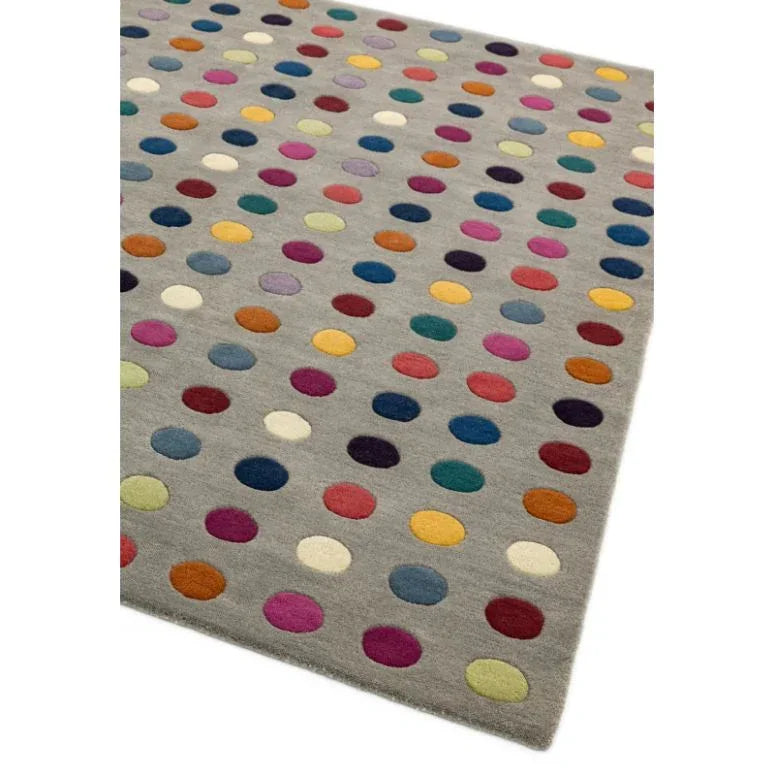 Grey wool rug with colorful polka dot pattern, angled corner view