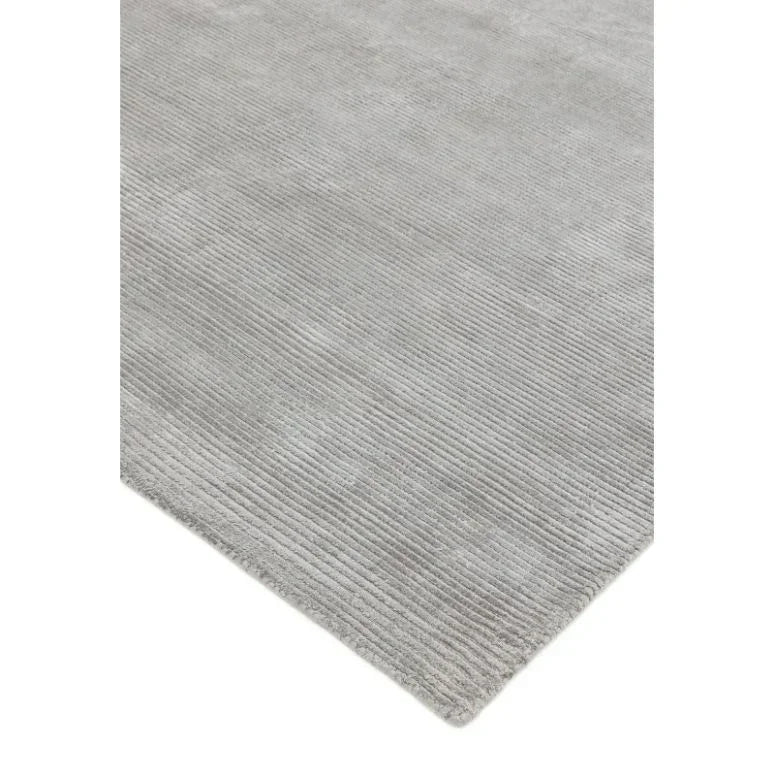 Light grey ribbed area rug with soft texture and finished edges, corner angle view