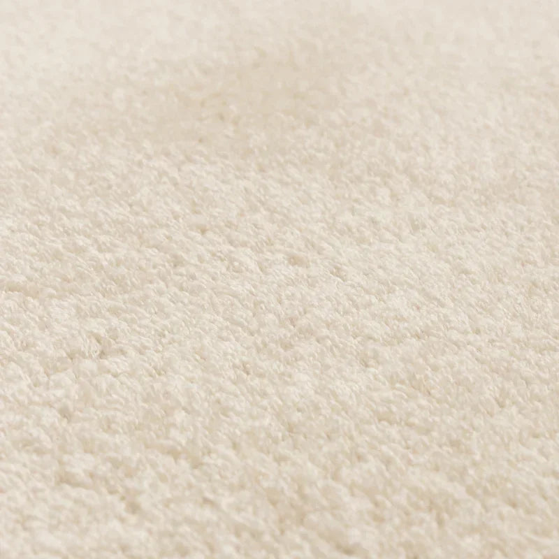 Close-up of cream shaggy rug texture with soft pile