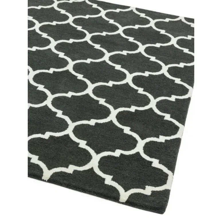 Black and white geometric patterned rug with trellis design, angled corner view