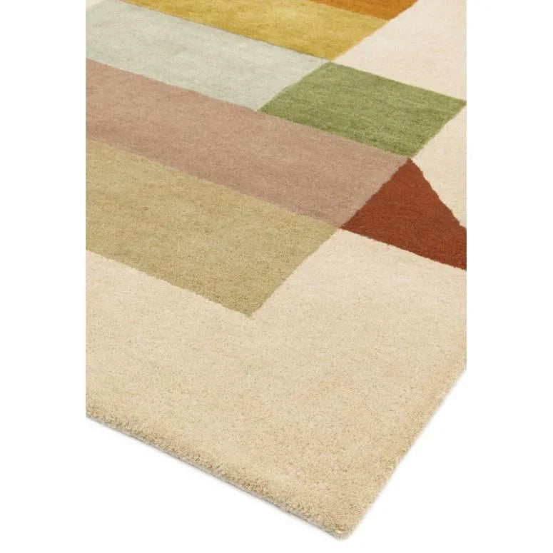 geometric wool rug with beige, green, yellow, and rust blocks, close corner view