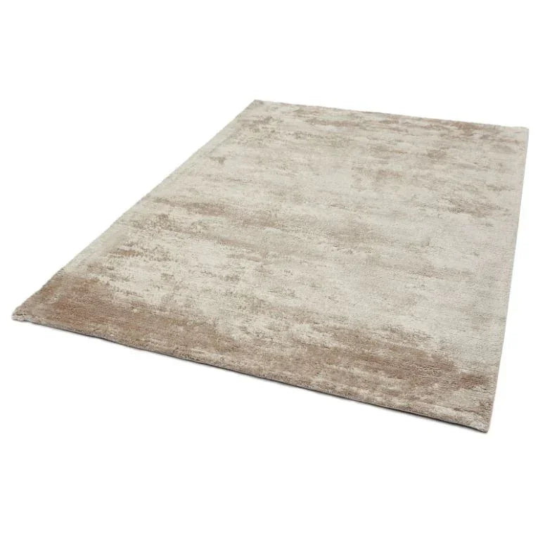 Beige area rug with soft textured pile shown from angled top view