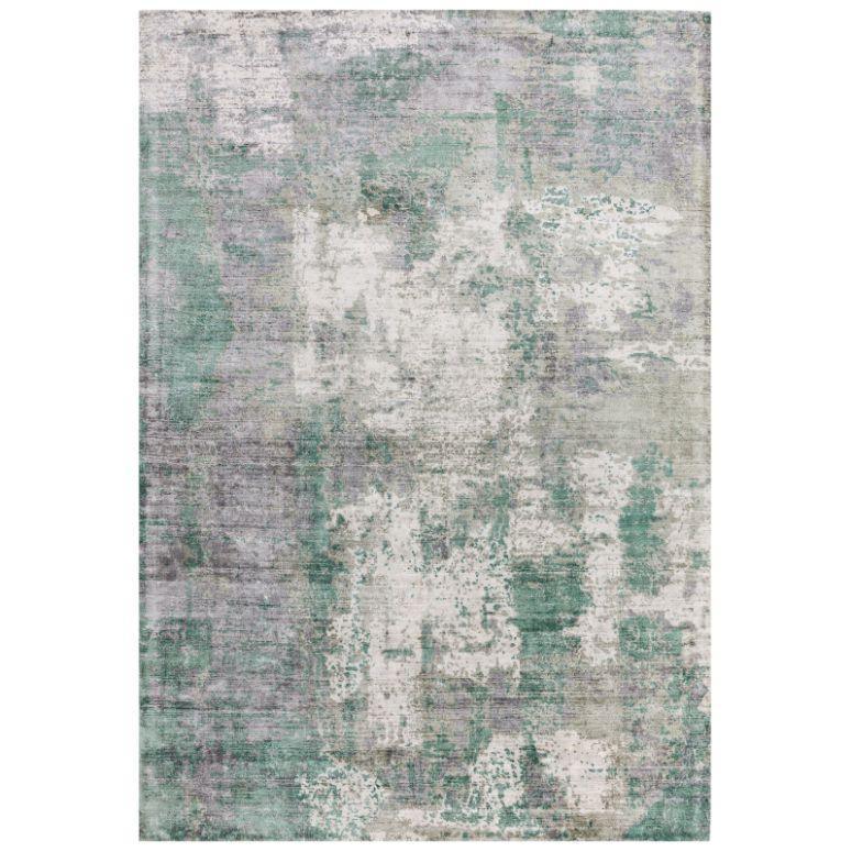 Abstract area rug with green, grey, and cream distressed pattern