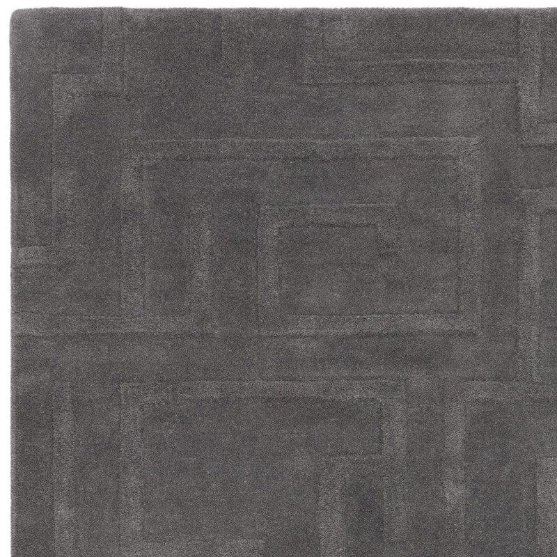 Dark grey geometric pattern rug with subtle texture, shown from overhead angle