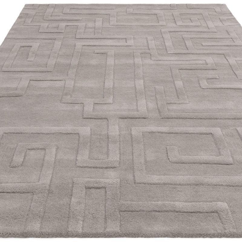 Light grey area rug with geometric pattern and raised textured design