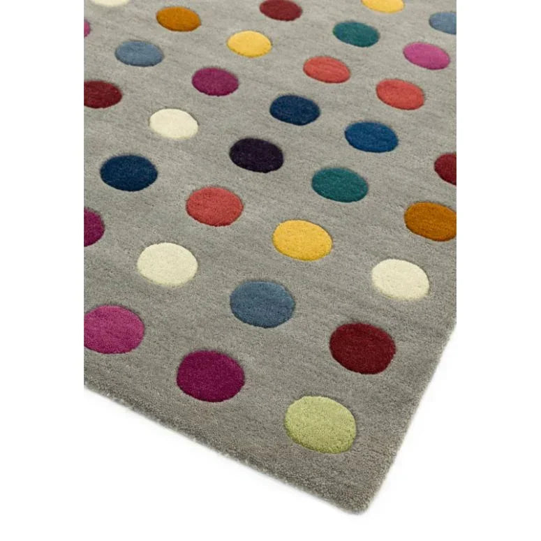 Grey wool rug with multicoloured polka dot pattern, corner angle view