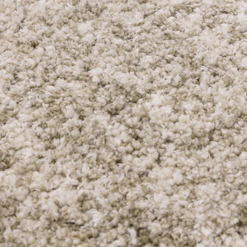 Close-up of cream shaggy rug texture with thick, soft pile