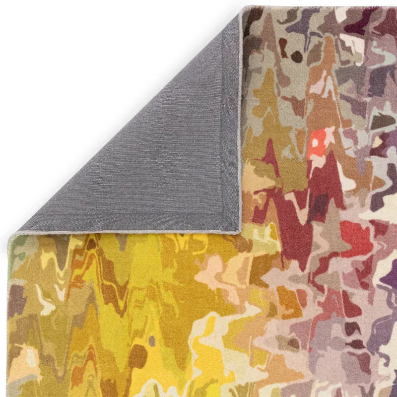 Abstract multicolor area rug with yellow, orange, purple patterns and grey fabric backing