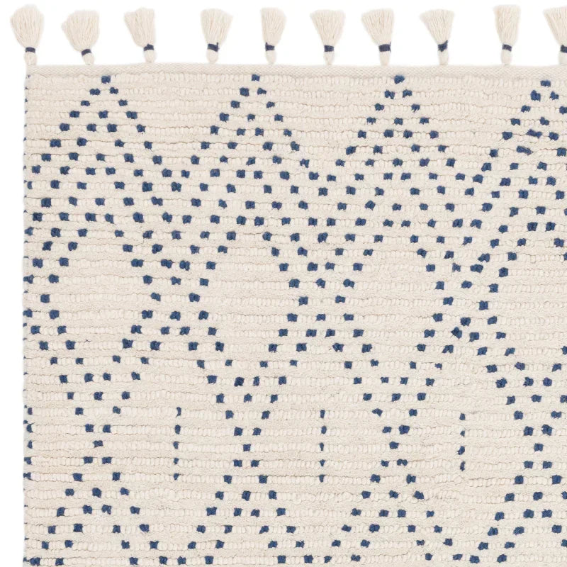 Cream and blue geometric area rug with tassels and textured woven pattern