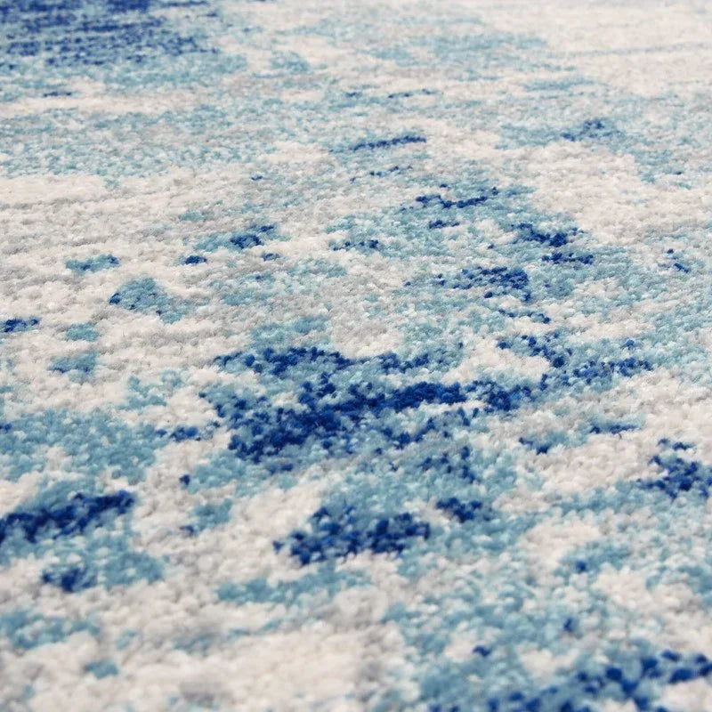 Close-up of blue and white patterned rug texture with soft pile