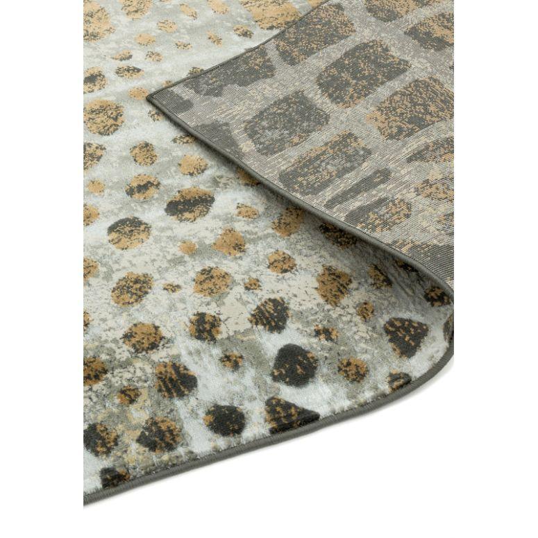 Leopard print area rug with beige, black, and grey pattern, corner folded to show backing