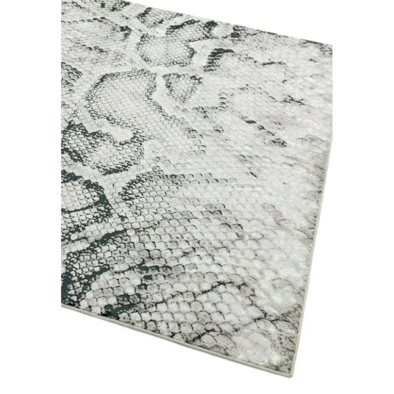 Grey and white area rug with snakeskin pattern and textured surface, angled corner view