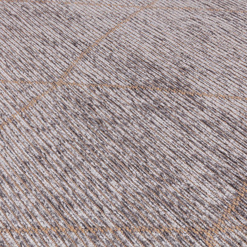 Close-up of textured grey area rug with subtle linear pattern and tan stitching detail