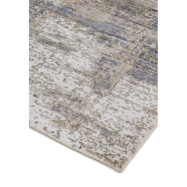 Beige and blue abstract area rug with textured pattern, close-up of corner detail