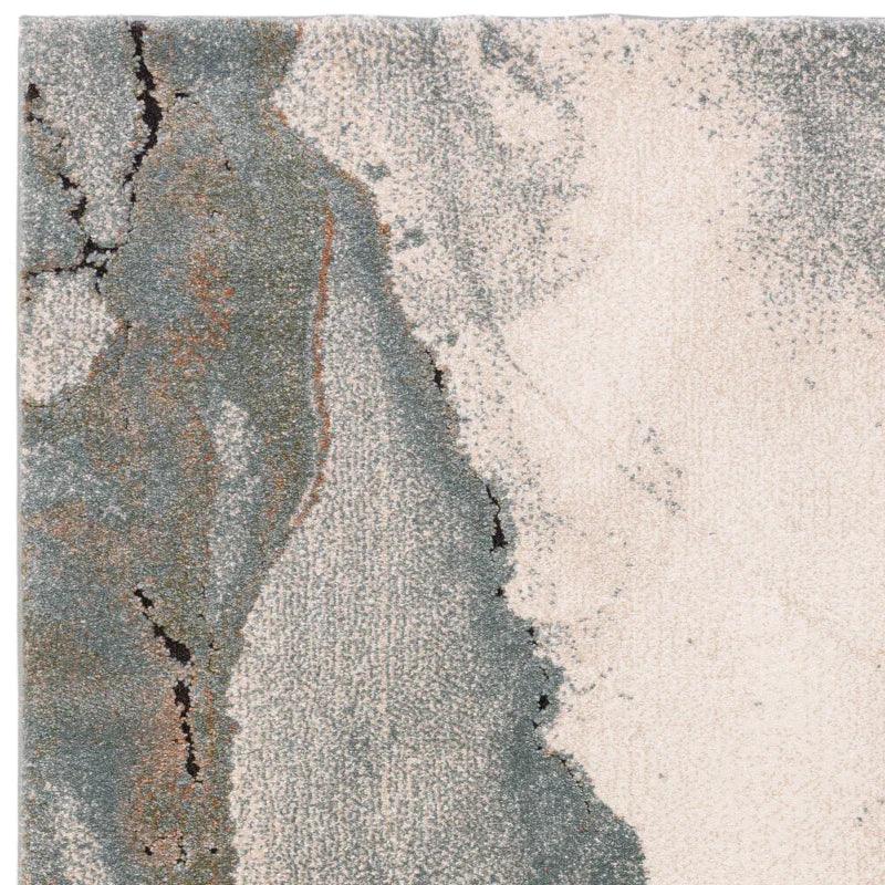 Abstract area rug with beige, grey, and charcoal marbled pattern, close-up texture view
