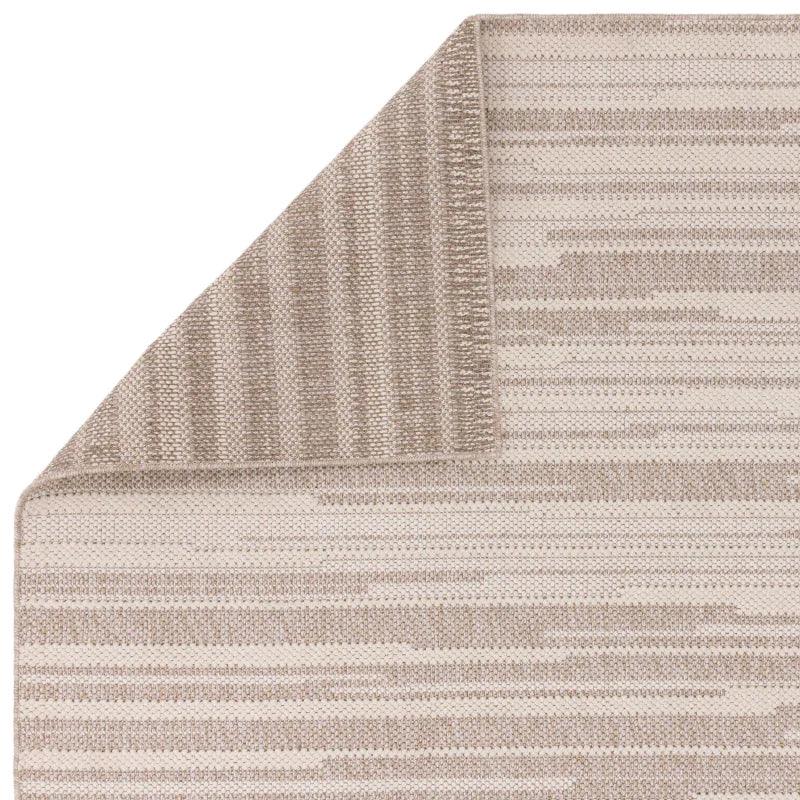Beige and cream striped woven rug corner detail with visible texture