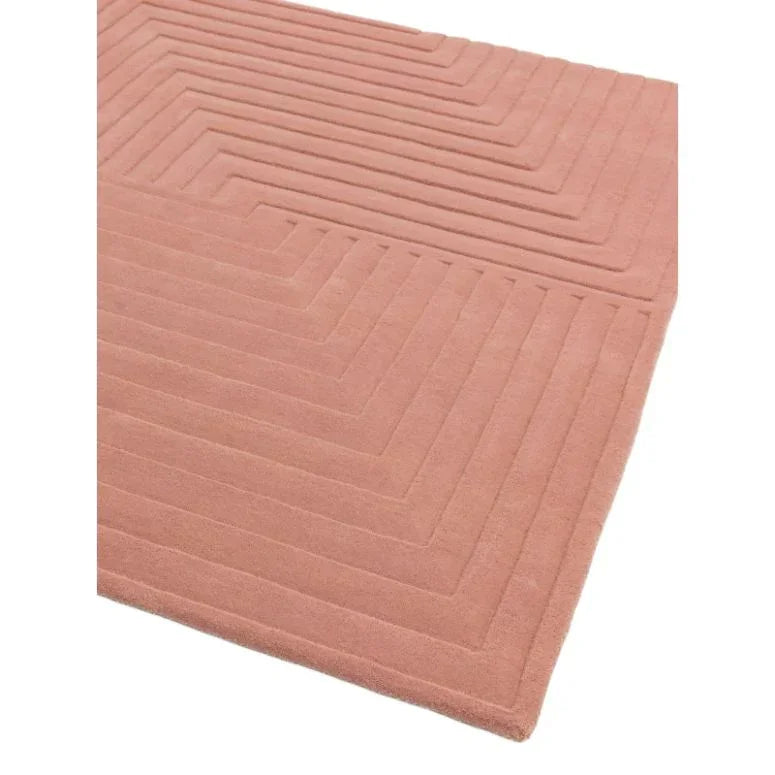 Pink geometric area rug with raised linear pattern and soft texture