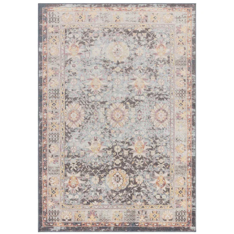 Floral pattern area rug with muted grey, blue and yellow tones, decorative border detail