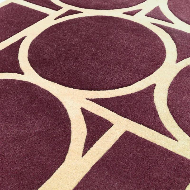 Plum and cream area rug with geometric circles and intersecting lines pattern