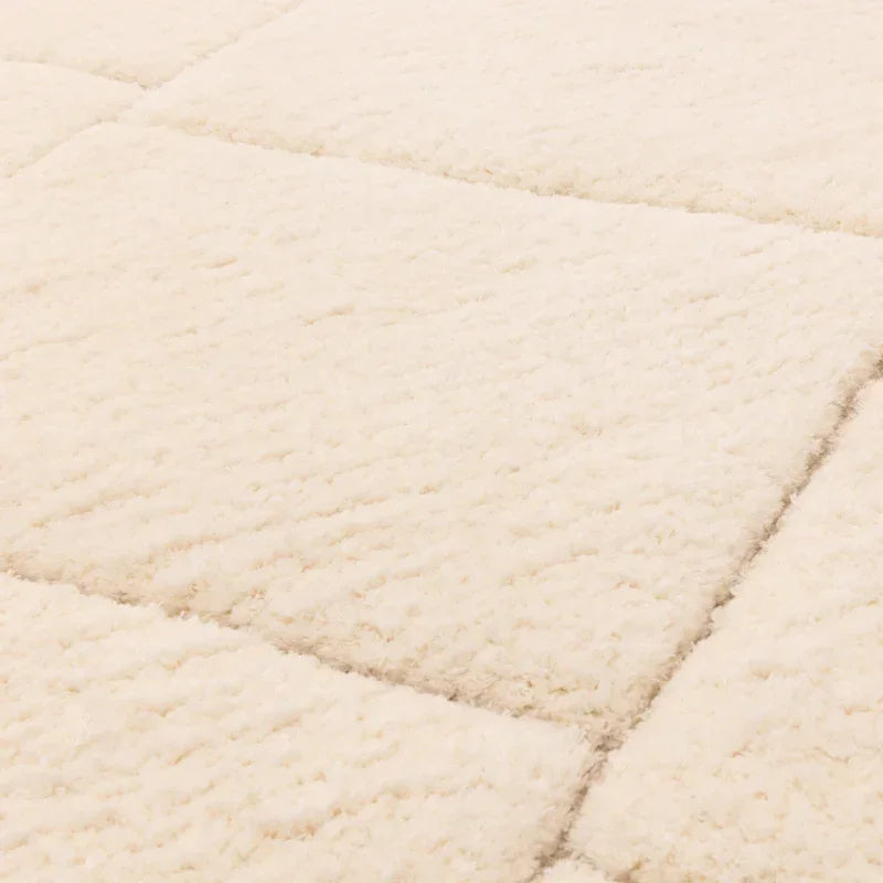 Close view of cream shaggy rug with soft textured diamond pattern