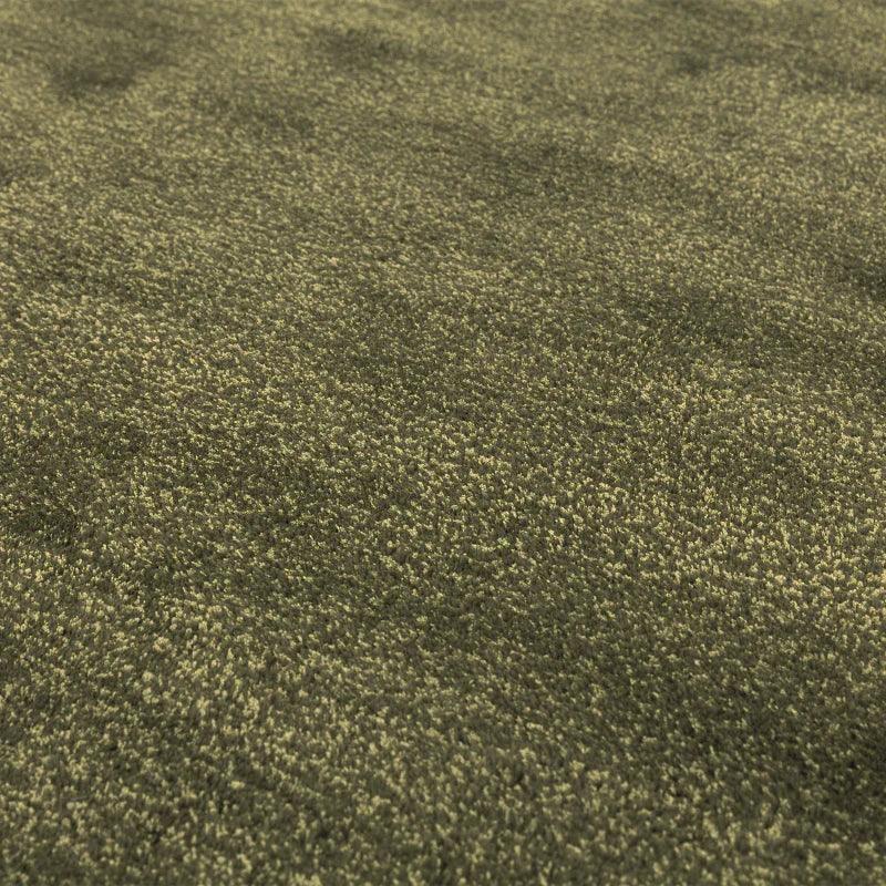 Close-up of olive green shaggy rug texture with soft, dense pile