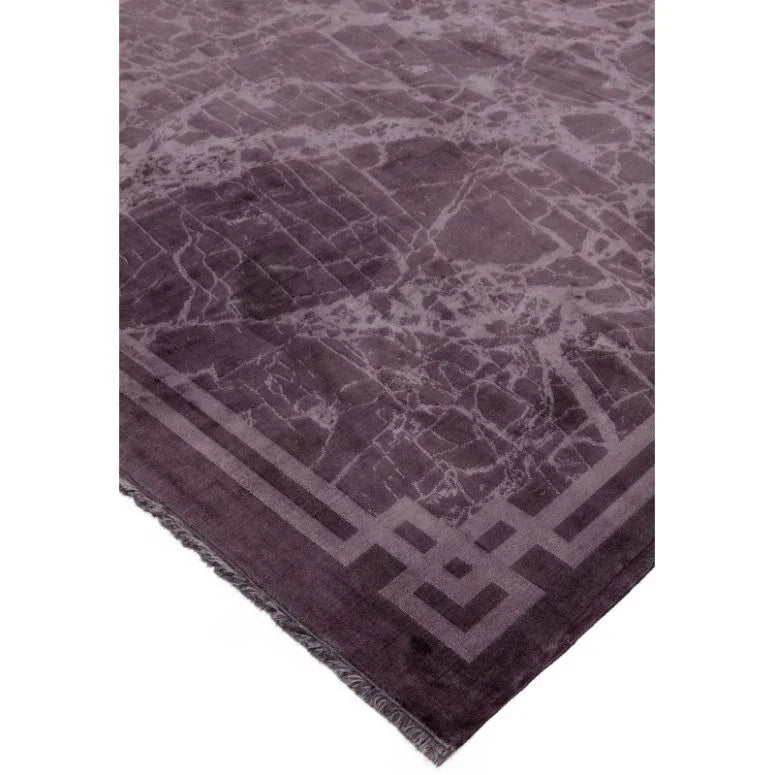 Purple area rug with geometric border and marble pattern detail