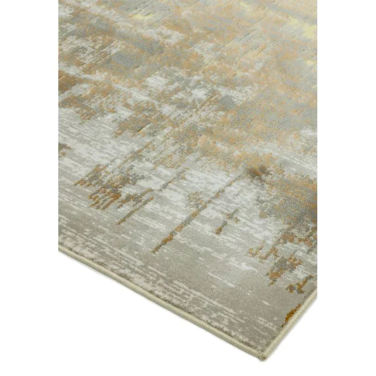 Corner of abstract beige and grey area rug with textured pattern